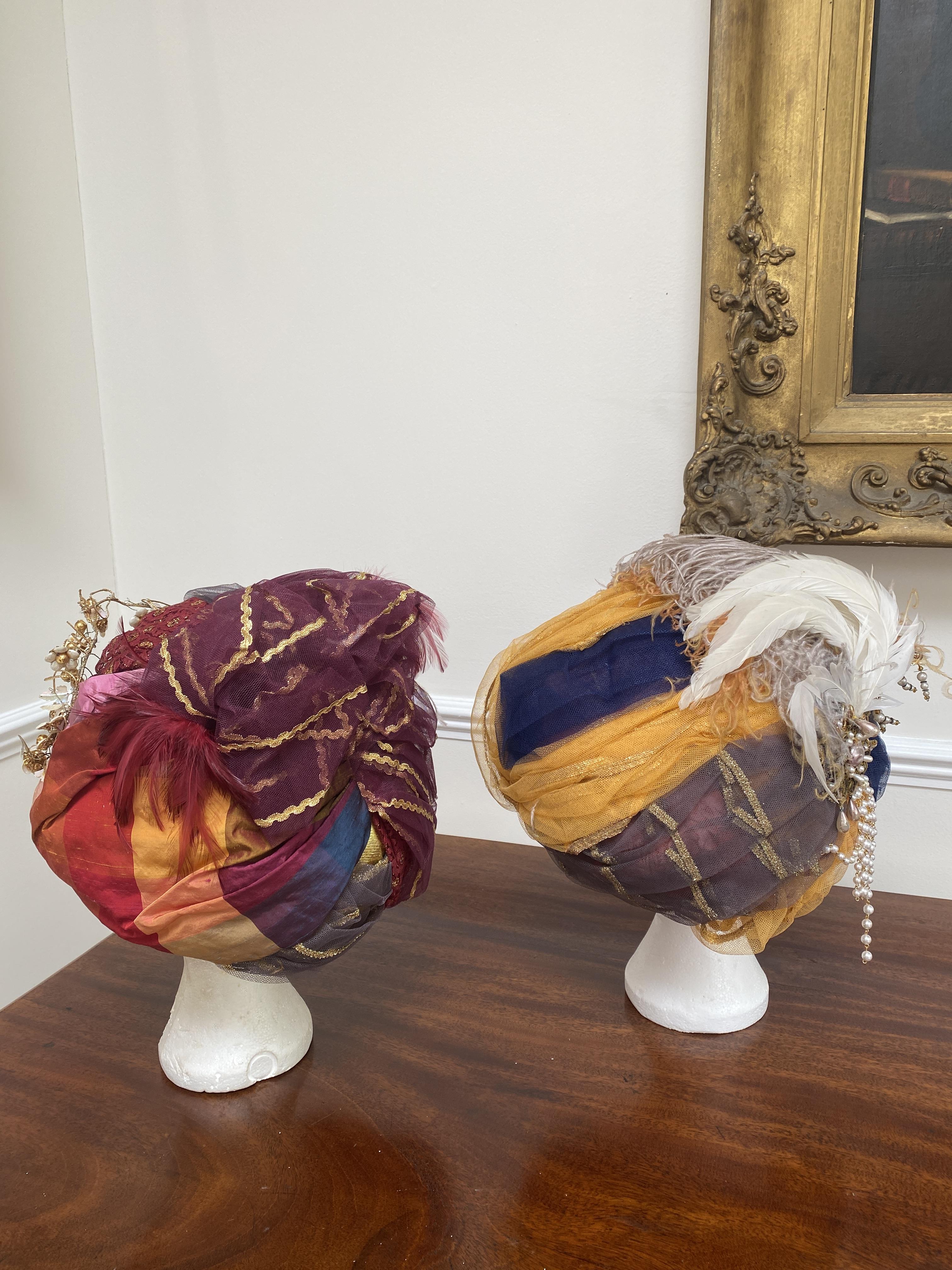 Two elaborate turbans, labelled Royal Opera House ‘Lucrezia Borgia', and two modern Indian turban hats